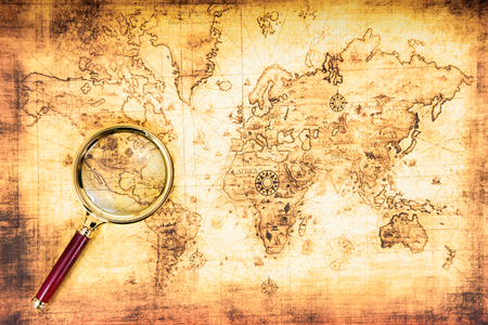 Old map with an magnifying glass explored it. Vintage travel backgroundの写真素材