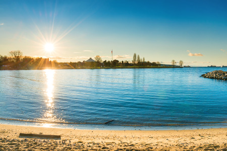 Beautiful sunset at the beach with blue sea water and shining sunの写真素材