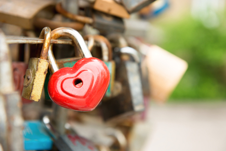 Love red romance lock with heart shape on the bridgeの写真素材