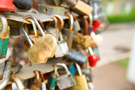 Love golden romance lock with heart shape on the bridgeの写真素材