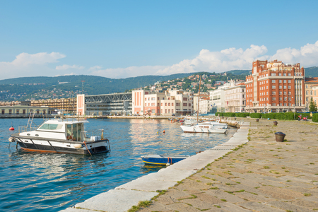 Sea harbor with boats near seafront in city of Trieste, Italyの写真素材