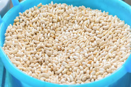 Bowl with white haricot beans at farm marketの写真素材