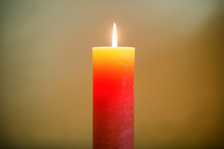 Candle light with flame on dark soft backgroundの写真素材