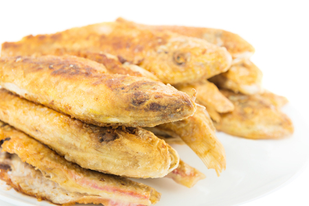 Dish of fried fishes red mullets isolated on white backgroundの写真素材