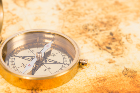 Old paper map with an ancient compass on it. Vintage travel backgroundの写真素材