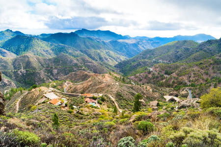 Nature landscape of Canary Island with mountain range, green hills and curvy roadの写真素材