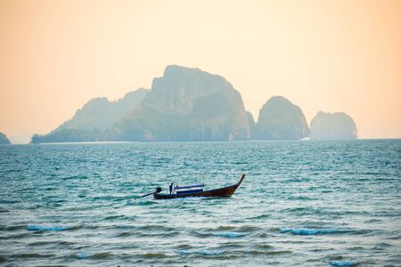 Landscape with traditional longtail boat in tropical sea with rock island. Krabi, Thailandの写真素材