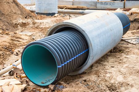 Big pipe or tube for water sewer on construction site during road repairの写真素材