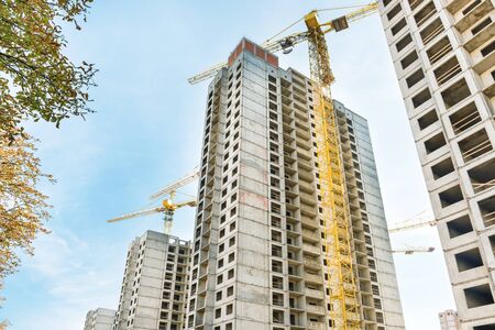 Construction site with buildings and industrial cranes