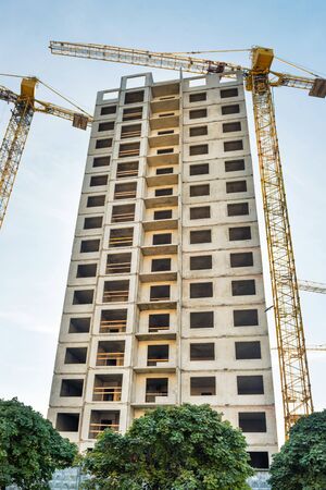 Construction site with buildings and industrial cranes