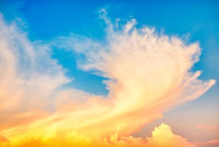 Beautiful cloudscape with blue sky and fluffy clouds at sunsetの写真素材