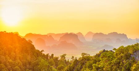 Beautiful panorama landscape with dramatic sunset, tropical rainforest and steep mountain ridge on...