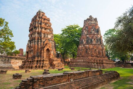 Historical and religious architecture of Thailand - ruins of old Siam capital Ayutthaya. View to brick remains of Wat Mahathat templeの写真素材