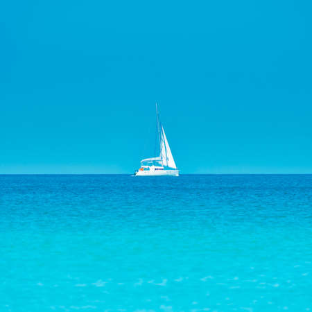 White yacht on blue sea with blue water and sky