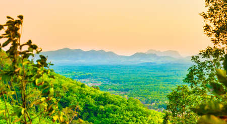 Green mountains with mist forest and sunset sky