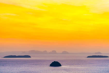 Small island landscape on sunset sea with colorful sunset skyの写真素材