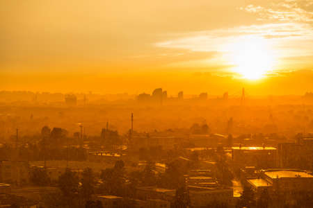 Cityscape with sunset in big city, moderm buildings under dramatic sunset skyの写真素材