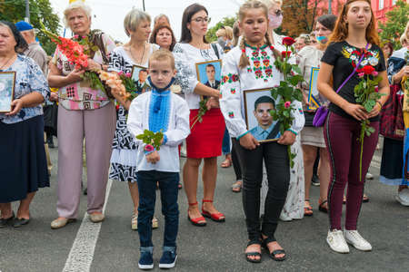 KIEV, UKRAINE - AUGUST 24, 2020: Children with portraits of their killed in war farthers on March of defenders, parade in Kyiv, dedicated to the Independence Day of Ukraine, 29th anniversary.のeditorial素材