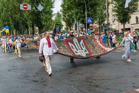 KIEV, UKRAINE - AUGUST 24, 2020: People with Ukrainian State on March of defenders, parade in Kyiv, dedicated to the Independence Day of Ukraine, 29th anniversary.のeditorial素材