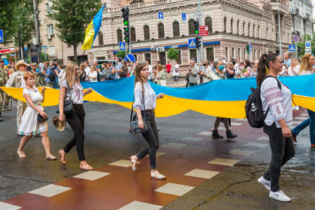 KIEV, UKRAINE - AUGUST 24, 2020: People, young women with Ukrainian flag on March of defenders, parade in Kyiv, dedicated to the Independence Day of Ukraine, 29th anniversary.のeditorial素材