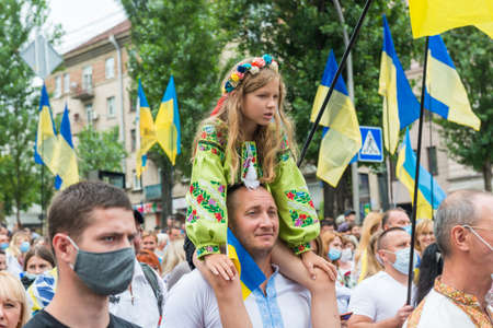 KIEV, UKRAINE - AUGUST 24, 2020: Father with little daughter on March of defenders, parade in Kyiv, dedicated to the Independence Day of Ukraine, 29th anniversary.のeditorial素材