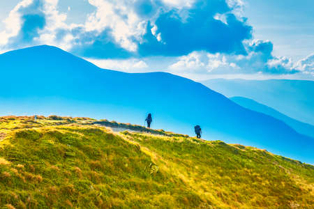 People travelling in mountains, mountain landscape with group of peopleの写真素材