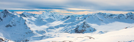 Snowy blue mountains in clouds. Winter ski resort