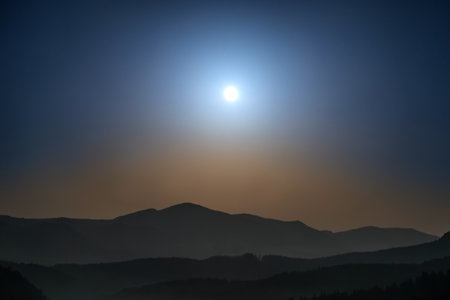 Panorama of mountains with full moon on night sky and starsの写真素材