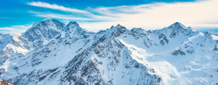 Snowy blue mountains in clouds. Winter ski resortの写真素材