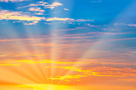 Sunset sky with sun rays and sunset cloudsの写真素材