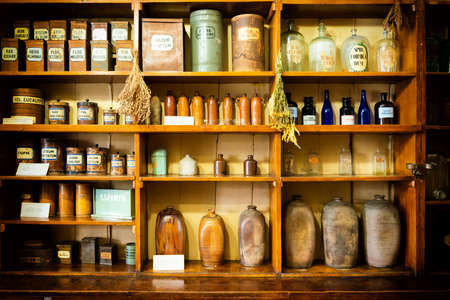 Old pharmacy cabinet with retro bottles and shelfs with medicamentsの写真素材