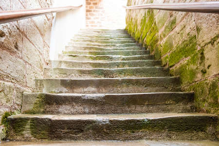 Old marble staircase stairway with moss stone stepsの写真素材