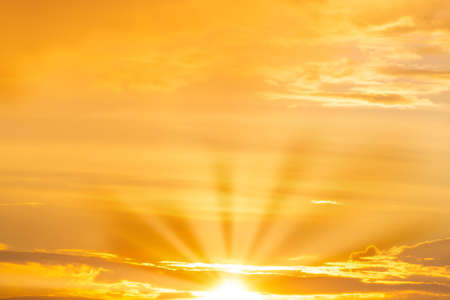 Sunset sky with sun rays and sunset cloudsの写真素材