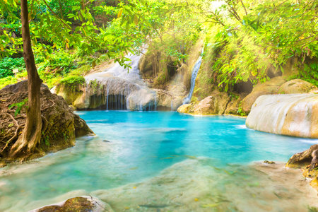 Tropical landscape with beautiful waterfall, emerald lake and rocks in wild jungle forest. Erawan National park, Kanchanaburi, Thailandの写真素材