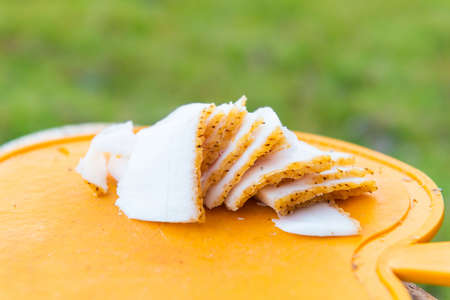 Slices of pig fat on board, cut fat for outdoor picnicの写真素材