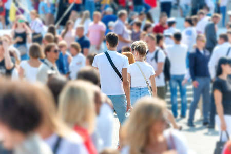 Crowd of people with men and women on busy city streetの写真素材