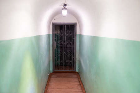 Corridor passage with door and lights in empty tunnelの写真素材