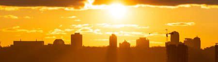 Panorama sunset in city with building silhouette and construction crane, Kiev cityの写真素材