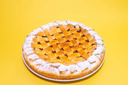 Tradition american apple pie with sugar crust on yellow backgroundの写真素材