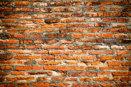 Texture of old red and brown brick wall as vintage backgroundの写真素材