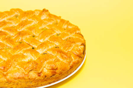 American pie with baked crust on yellow backgroundの写真素材