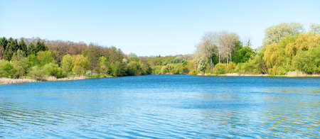 River lake landscape with blue water and forestの写真素材