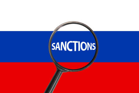 Sanctions against aggressor Russia with magnifier glass, economic and political sanctions against Russia, sanctions on Russian flagの写真素材