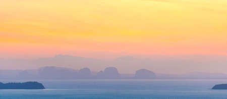 Mountain landscape on sunset sea with colorful sunset skyの写真素材