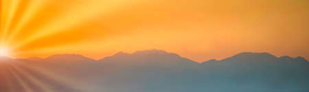 Mountains sunset panorama landscape with sunset skyの写真素材
