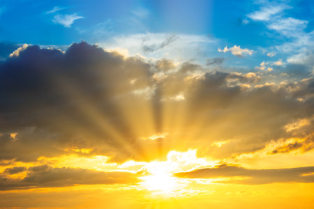 Sunset sky with sunset clouds, sun rays and gramatic skyの写真素材