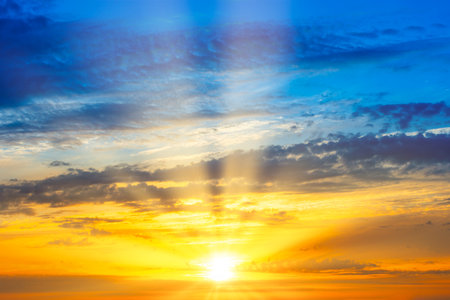 Sunset sky with sunset clouds, sun rays and gramatic skyの写真素材
