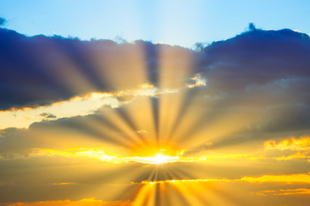 Sunset sky with sunset clouds, sun rays and gramatic skyの写真素材