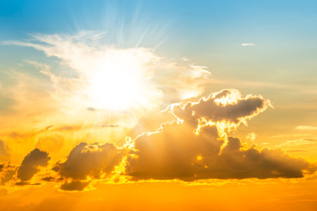 Sunset sky background with sun and sunset cloudsの写真素材