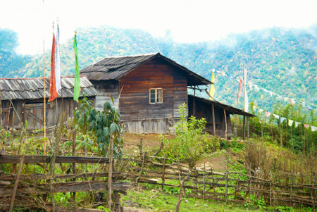 Old wooden indian house with prayer flags in Himalayas mountains. Sikkim, Indiaの写真素材